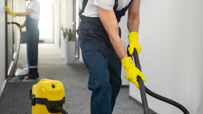Expert floor cleaning professional using advanced tools to clean a shiny surface.
