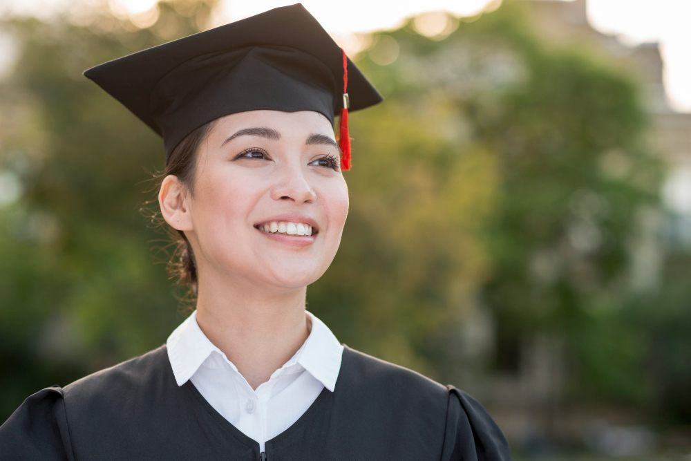 A female student smiling in convocation
