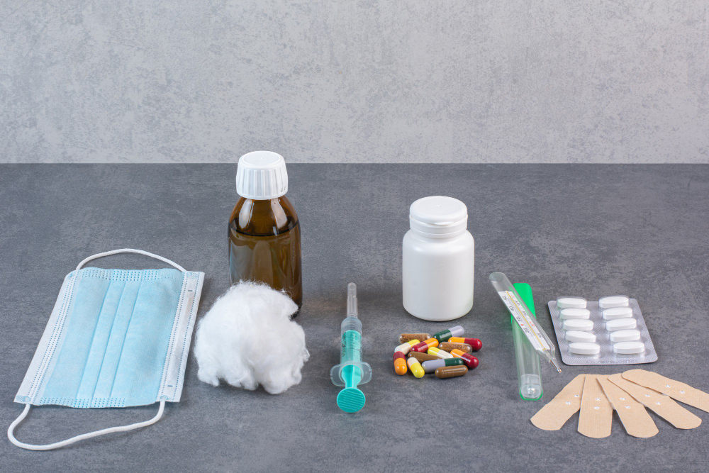 Medical supplies arranged on a table, featuring an urgent care kit with antibiotics for home treatment.