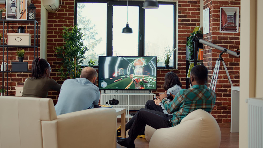 Friends gathered in a living room, engaged in video gaming, highlighting a fun and interactive entertainment experience.